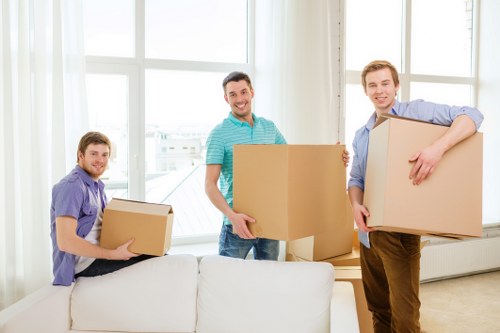 Furniture being carefully carried through a narrow flat stairwell